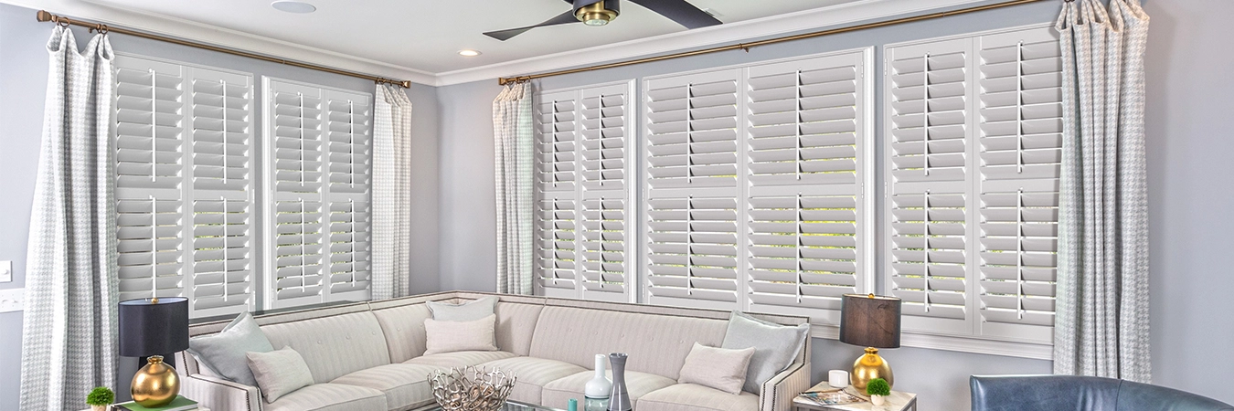 whiteshuttersbluedecorlivingroomWhite Polywood plantation shutters on living room windows