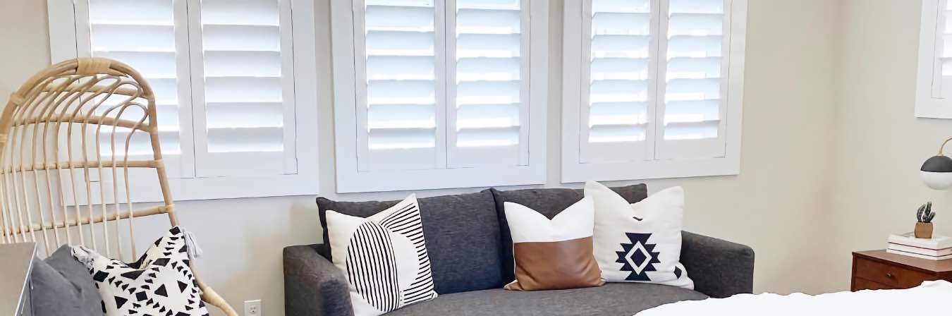 White Polywood plantation shutters on a bedroom window