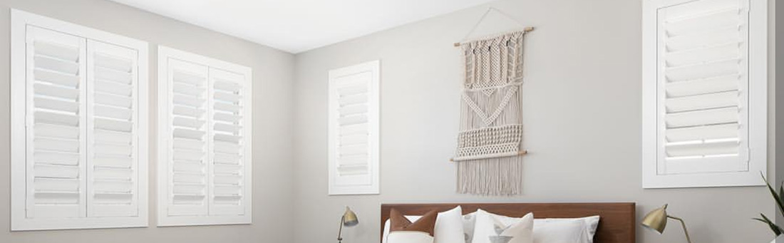 White Polywood shutters in a large bedroom