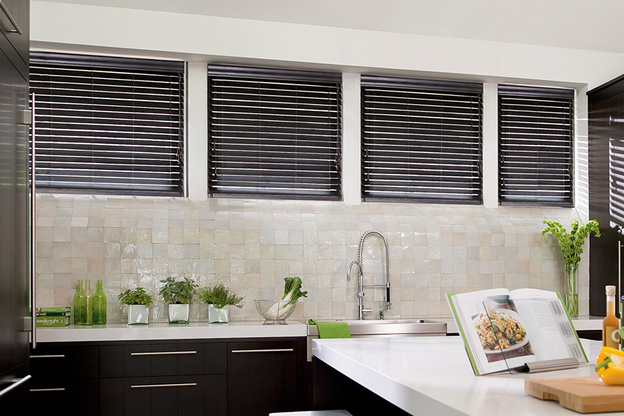 Choose custom Polywood faux wood blinds for your kitchen in Phoenix. Special shaped faux wood blinds in several windows above a sink.