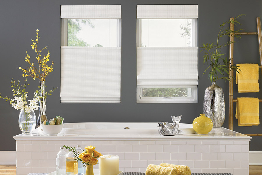 White top-down/bottom-up window shades on two windows in a gray bathroom with yellow accents