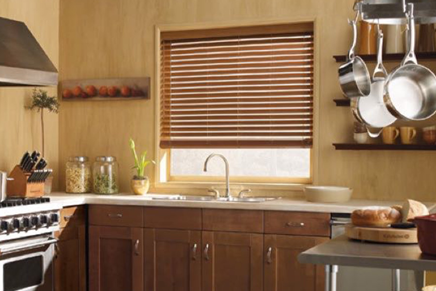 Blinds won't warp when installed over sinks or other rooms with humidity. faux-wood blinds stained light oak