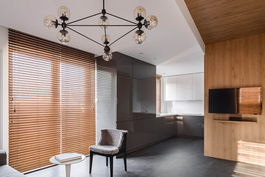 If you like window blinds, you'll get the most out of them if you purchase high-quality wood or faux-wood blinds. Brown wood window blinds on a large window