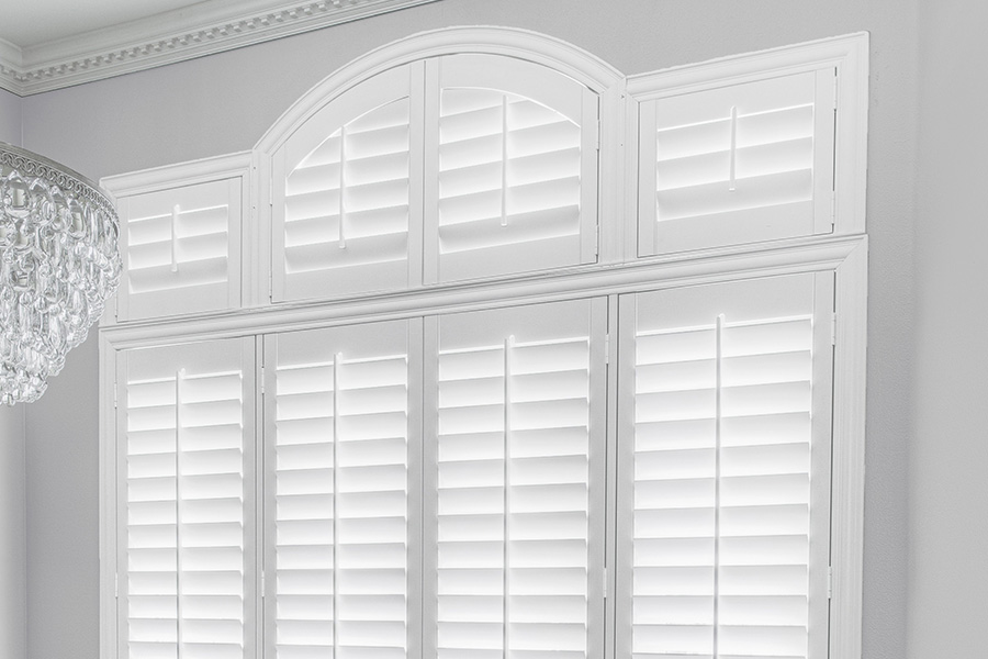Customize your Palladian windows with white Polywood shutters in Phoenix. White Polywood Palladian windows in a dining room.