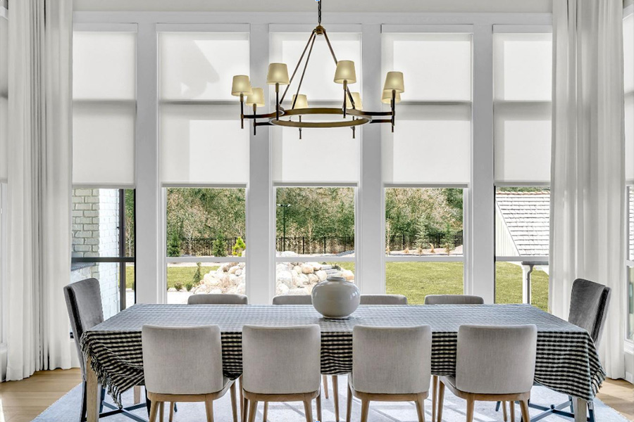 Opaque roller shades do an excellent job of blocking light and providing privacy. white colored roller shades in living room windows
