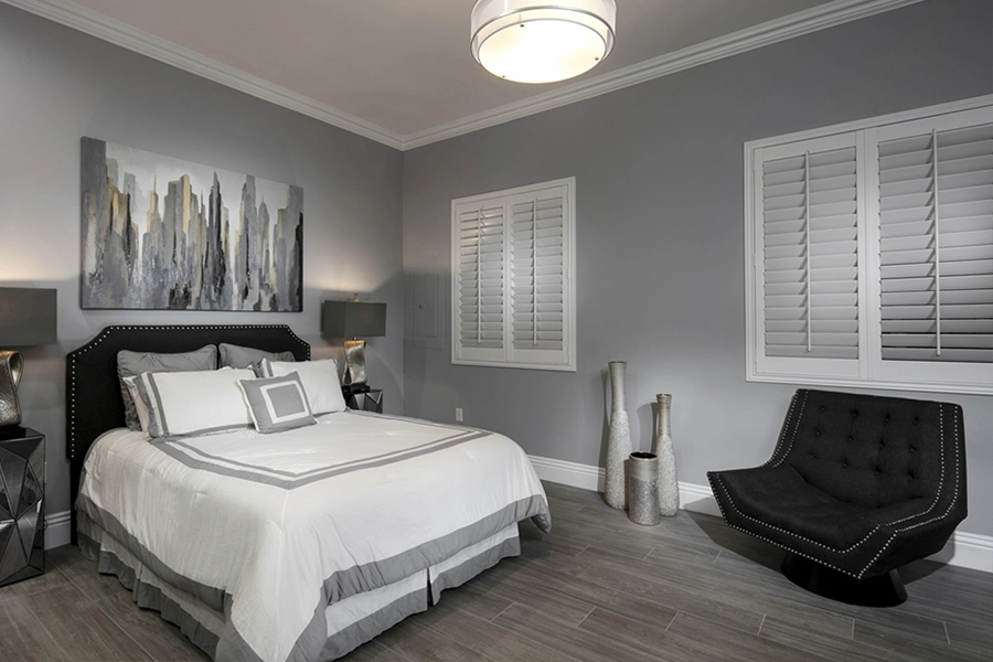 Close your custom Polywood shutters to beat the heat and keep your Phoenix bedroom cool. White Polywood shutters on bedroom windows