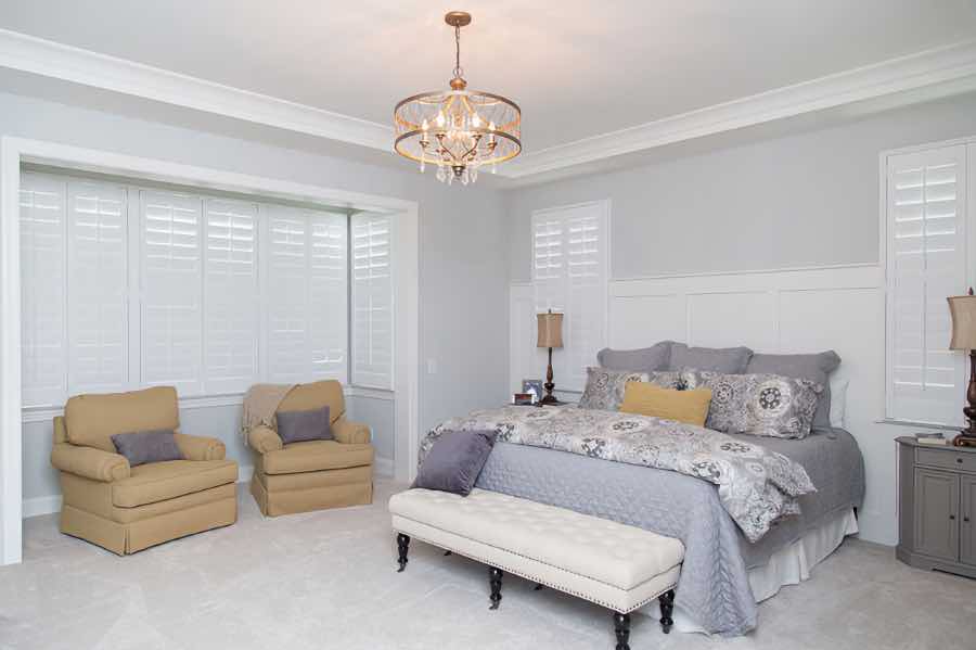 Polywood shutters are specially designed for excellent insulation to keep your home comfortable. Closed Polywood shutters on three living room windows