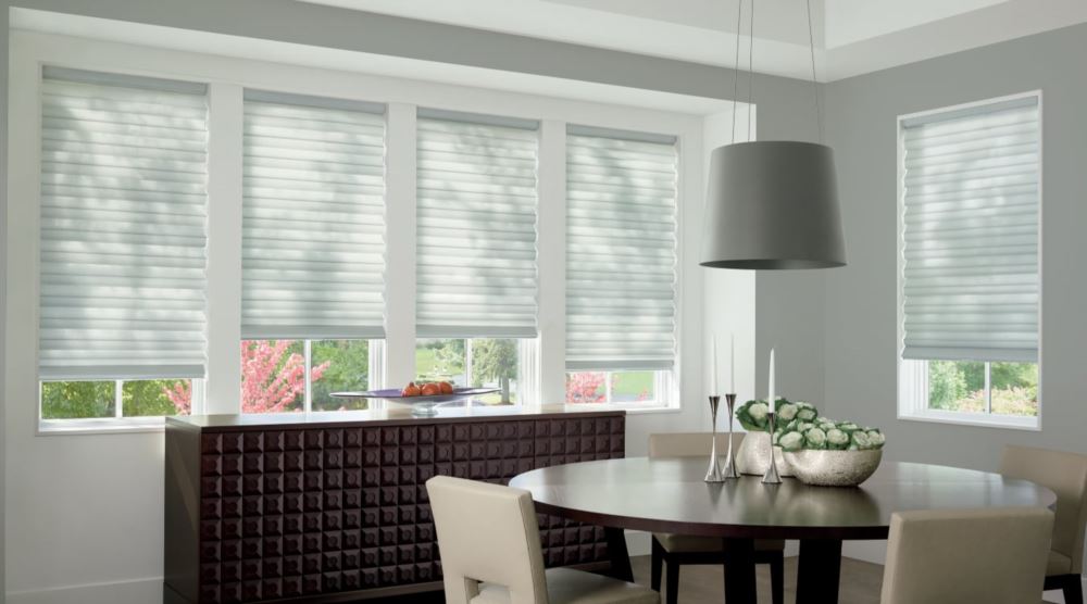 Custom cordless roller shades have a clean look and are appropriate for any room. Cordless motorized shades in a Phoenix dining room
