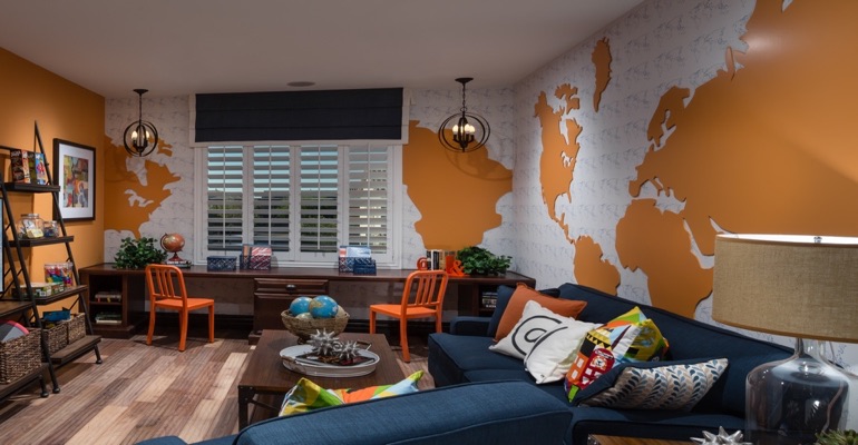 Plantation shutters are an ideal window treatment for a study center. Family room with wall map and plantation shutters