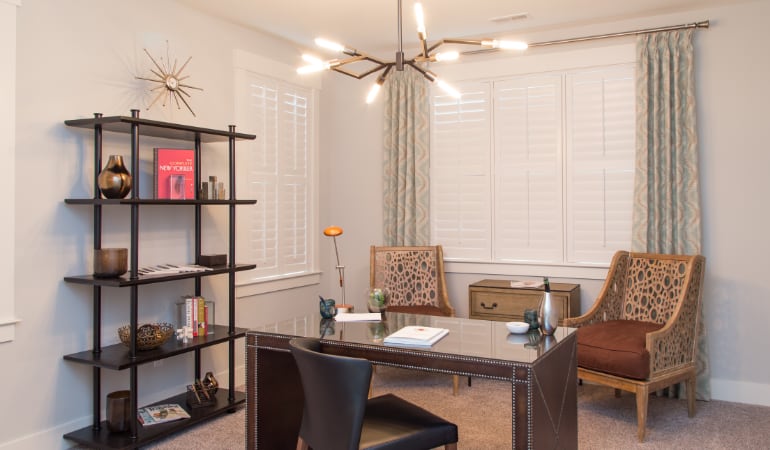 Picking the right window treatments can result in an increase in natural light. Phoenix home office with plantation shutters.