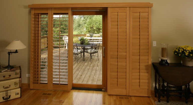 Wood shutters create a buffer that transitions from indoor wood to patio. Phoenix wood shutter sliding door