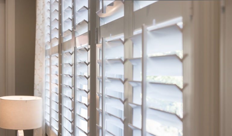 East-West windows have glare problems during sunrises and sunsets. Plantation shutters close up
