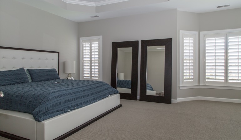 Polywood plantation shutters work well with minimalist design. Polywood shutters in a minimalist bedroom in Phoenix.
