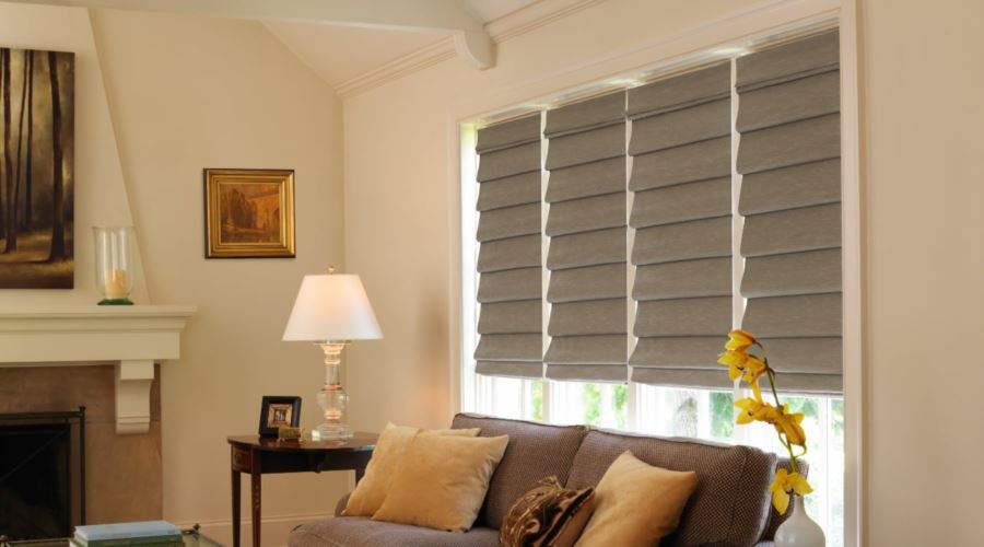 Roman shades are easy to operate and are available in a variety of shades and patterns. Roman shades in a living room