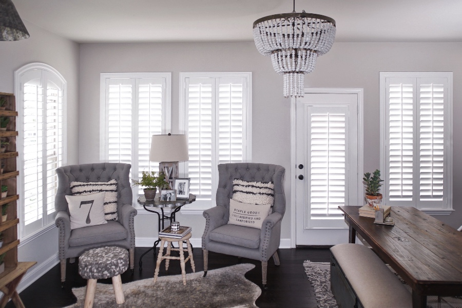 Polywood shutters are durable and pet-friendly. Photo credit: Whimsy Girl Interior Designs White interior shutters in a modern farmhouse living room.