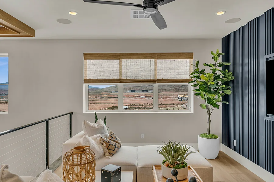 Phoenix homeowners who want eco-friendly home fixtures should consider natural woven shades. Natural brown woven shades on a window in a stylish sitting area