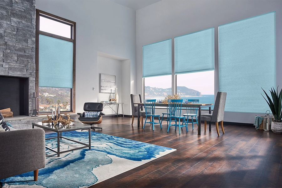 Smart motorized window shades are perfect on tall windows in your Phoenix home. Blue motorized shades on tall living room windows