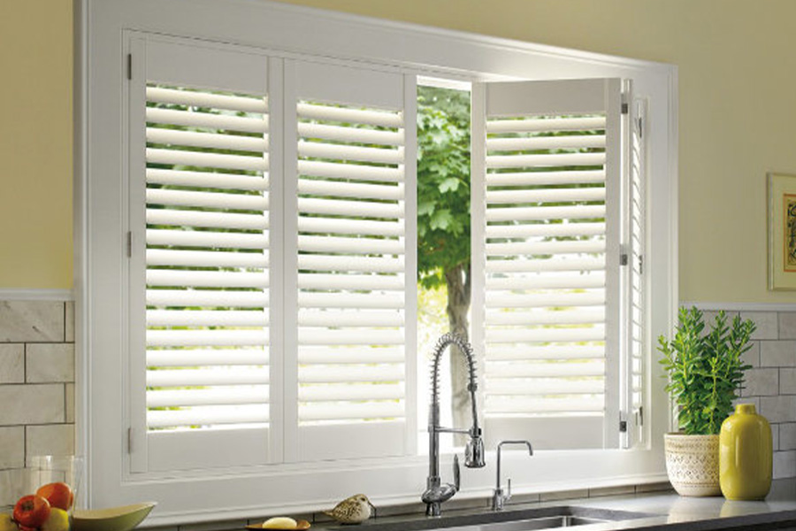 Polywood shutters are built to withstand the test of time in Phoenix. White Polywood shutters above a kitchen sink.